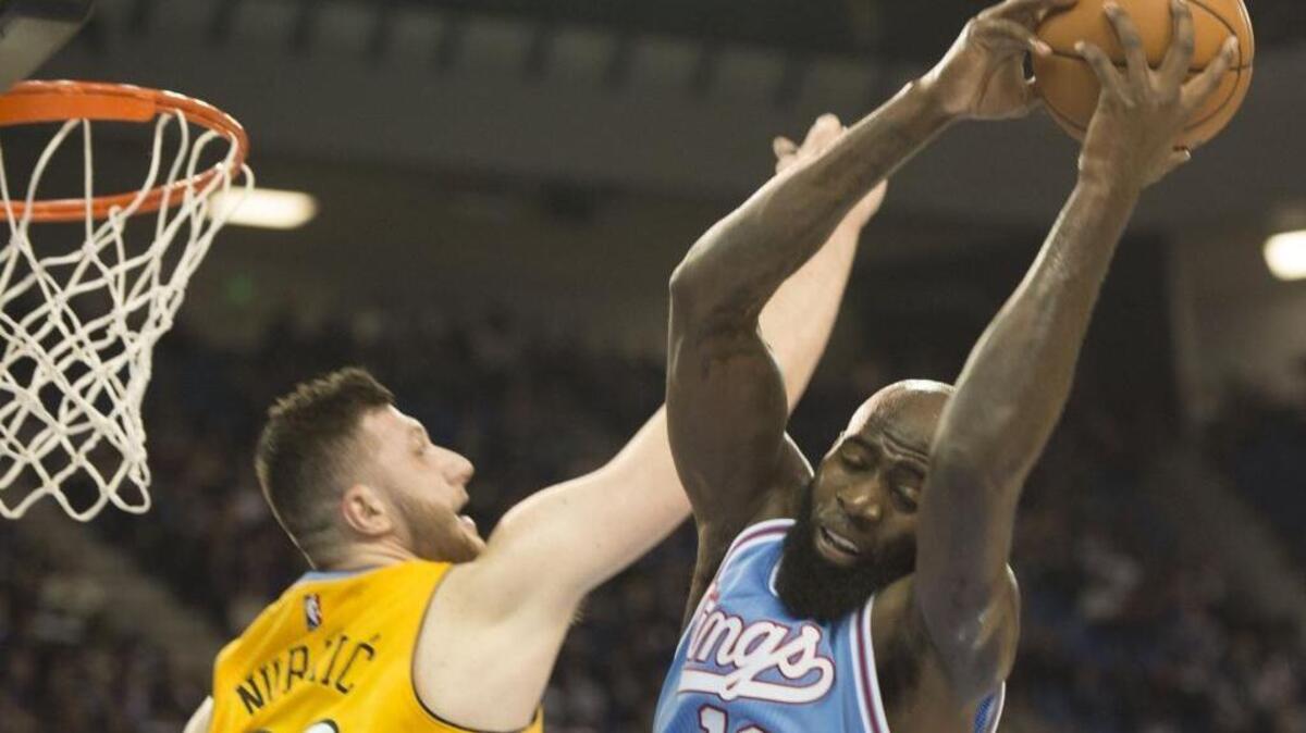 Kings forward Quincy Acy pulls down a defensive rebound over Denver Nuggets center Jusuf Nurkic during Friday’s game at Sleep Train Arena.
