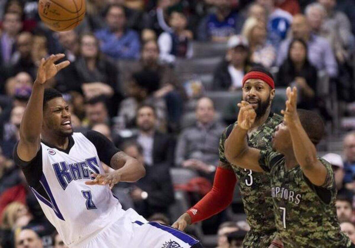 
Forward Rudy Gay (8), passing against Toronto Raptors Kyle Lowry (7) and James Johnson (3), will be back in action with his Sacramento Kings teammates as they complete their current road trip with a game Saturday against the Indiana Pacers.
