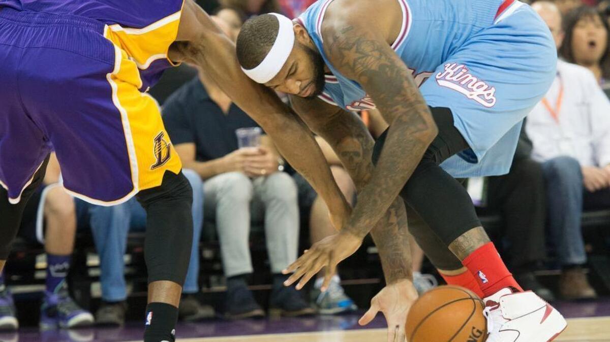 Kings center DeMarcus Cousins, right, fights for the ball against Los Angeles Lakers forward Kobe Bryant (24) on Friday, Oct. 30, at Sleep Train Arena in Sacramento.