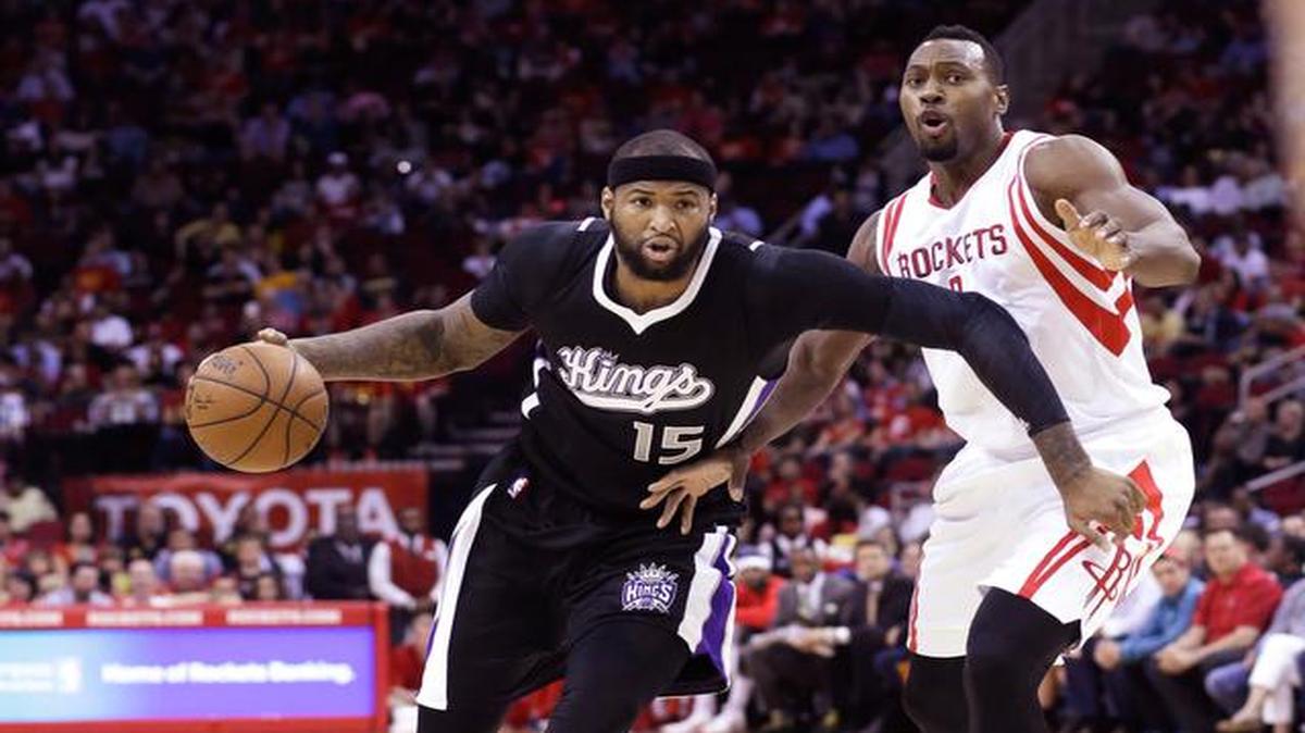
DeMarcus Cousins drives past Houston Rockets' Joey Dorsey in the first half of an NBA basketball game Wednesday, April 1, 2015, in Houston.
