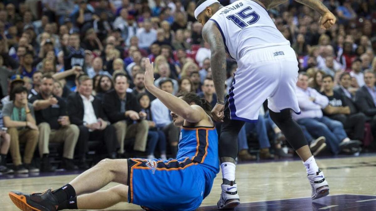 Sacramento Kings center DeMarcus Cousins (15) makes a fist after he struggled to free his foot from the body of Oklahoma City Thunder center Steven Adams (12) `during the Kings loss at Sleep Train Arena on Monday, Feb. 29, 2016, in Sacramento.