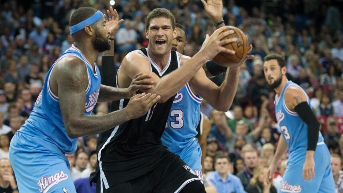 Brooklyn Nets center Brook Lopez (11) drives to the basket against Kings forward DeMarcus Cousins (15) at Sleep Train Arena in Sacramento on Friday, Nov. 13, 2015.