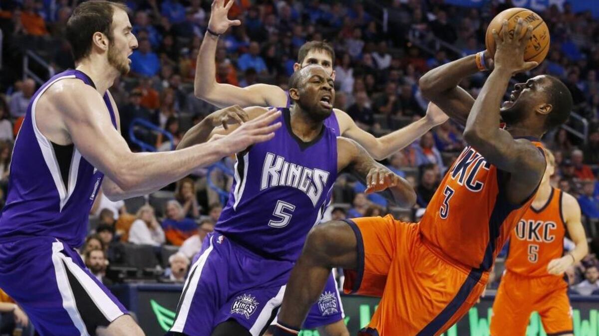 Sacramento Kings center Kosta Koufos, left, and guard James Anderson (5) pressure Oklahoma City Thunder guard Dion Waiters during their game on Sunday, Dec. 6, 2015. The Kings are back in action at Sleep Train Arena against the Utah Jazz on Tuesday, Dec. 8, 2015.