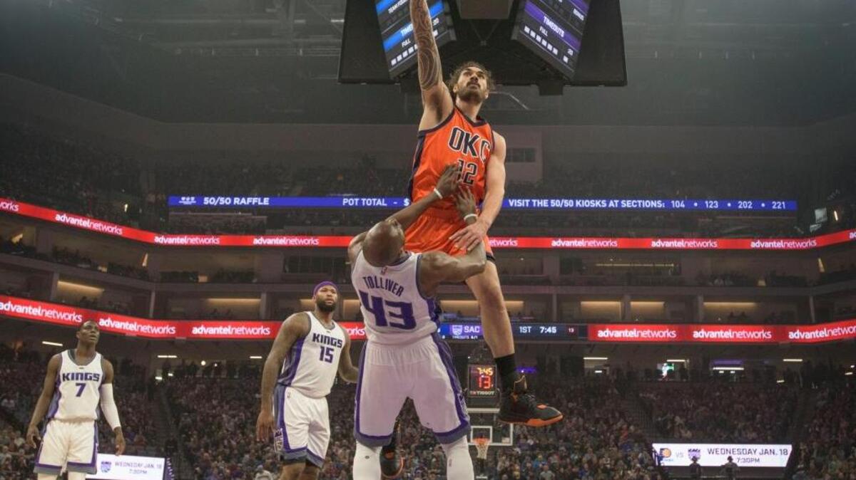 Kings forward Anthony Tolliver (43) draws a charge on Oklahoma City Thunder center Steven Adams (12) at Golden 1 Center in Sacramento on Jan. 15.