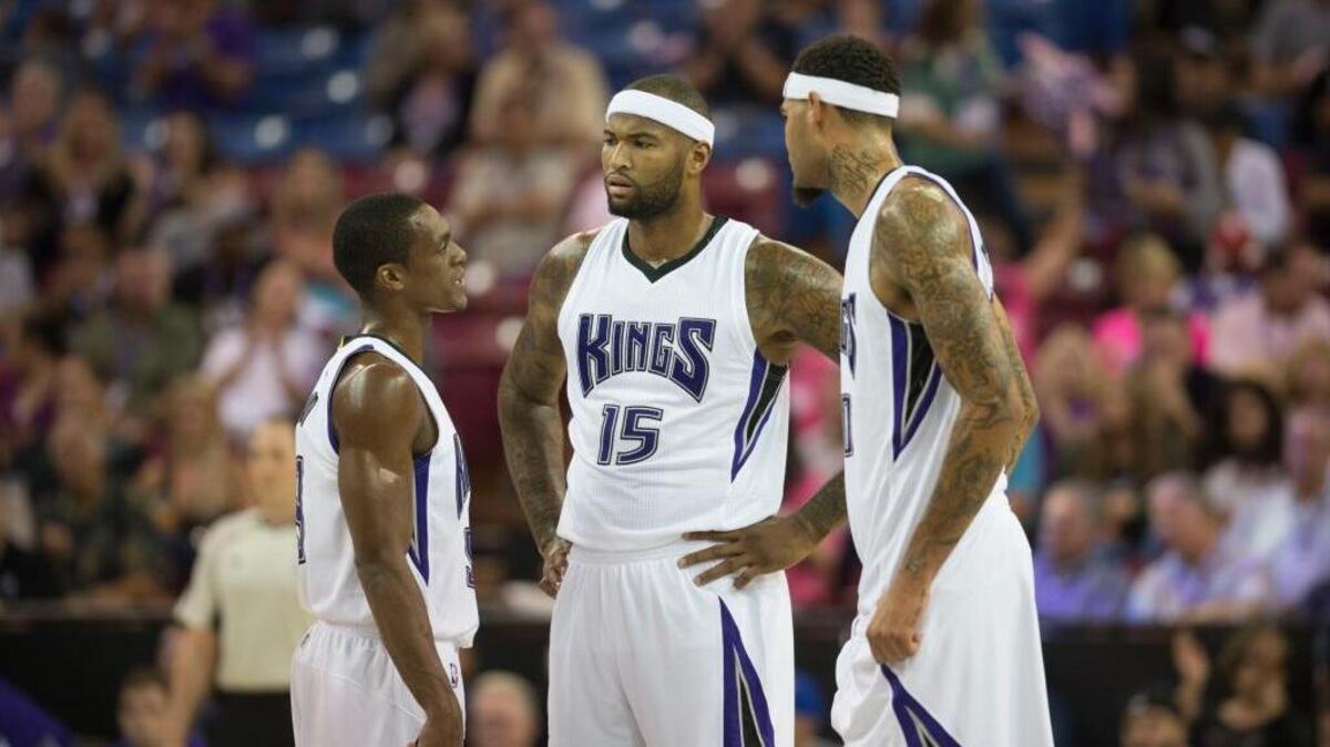 Kings guard Rajon Rondo, left, talks with center DeMarcus Cousins (15) and center Willie Cauley-Stein during their preseason game on Oct. 8 at Sleep Train Arena in Sacramento.