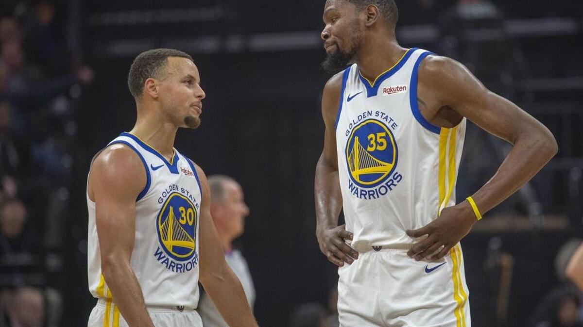 Golden State Warriors guard Stephen Curry (30) and teammate Golden State Warriors forward Kevin Durant (35) talk during their game against the Sacramento Kings at the Golden One Center on Friday, Dec.14, 2018.