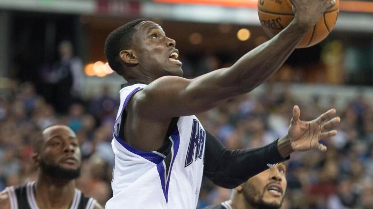 Kings guard Darren Collison (7) puts up a shot as the Spurs’ Jonathon Simmons, left, and Boris Diaw look on in Wednesday night’s game at Sleep Train Arena.