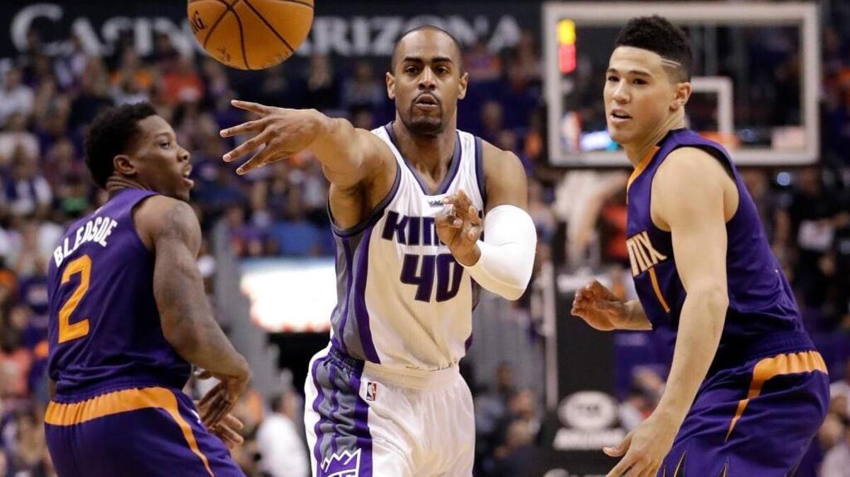 Kings guard Arron Afflalo (40) passes between Phoenix Suns guards Eric Bledsoe (2) and Devin Booker during the first half of the teams’ meeting on Oct. 26, 2016, in Phoenix.