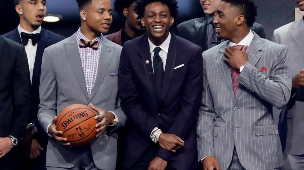 De’Aaron Fox, center, is the newest King. The Kentucky point guard was picked by Sacramento with the fifth pick in the NBA draft Thursday.