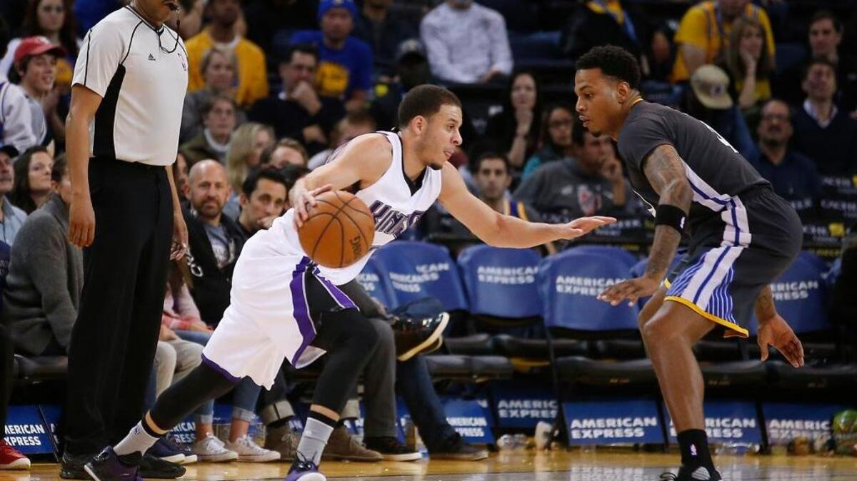 Sacramento Kings guard Seth Curry (30) drives past Golden State Warriors guard Brandon Rush, right, during an NBA basketball game Saturday, Nov. 28, 2015, in Oakland. Curry scored nine points in nine minutes. He made three three-point shots in the fourth quarter.