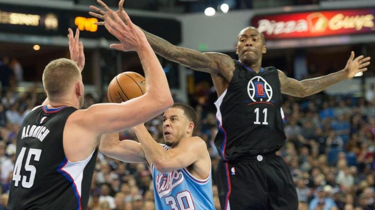Sacramento Kings guard Seth Curry (30) attracts Los Angeles Clippers defenders Cole Aldrich (45) and Jamal Crawford (11) during an NBA basketball game, Friday, Feb. 26, 2016 at Sleep Train Arena in Sacramento. Curry scored a career-high 19 points.