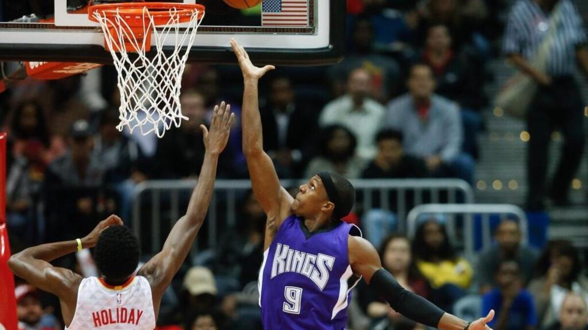 Kings guard Rajon Rondo goes up against Atlanta Hawks guard Justin Holiday on Wednesday, Nov. 18, 2015, in Atlanta. Rondo had a triple double but the Kings fell 103-97.