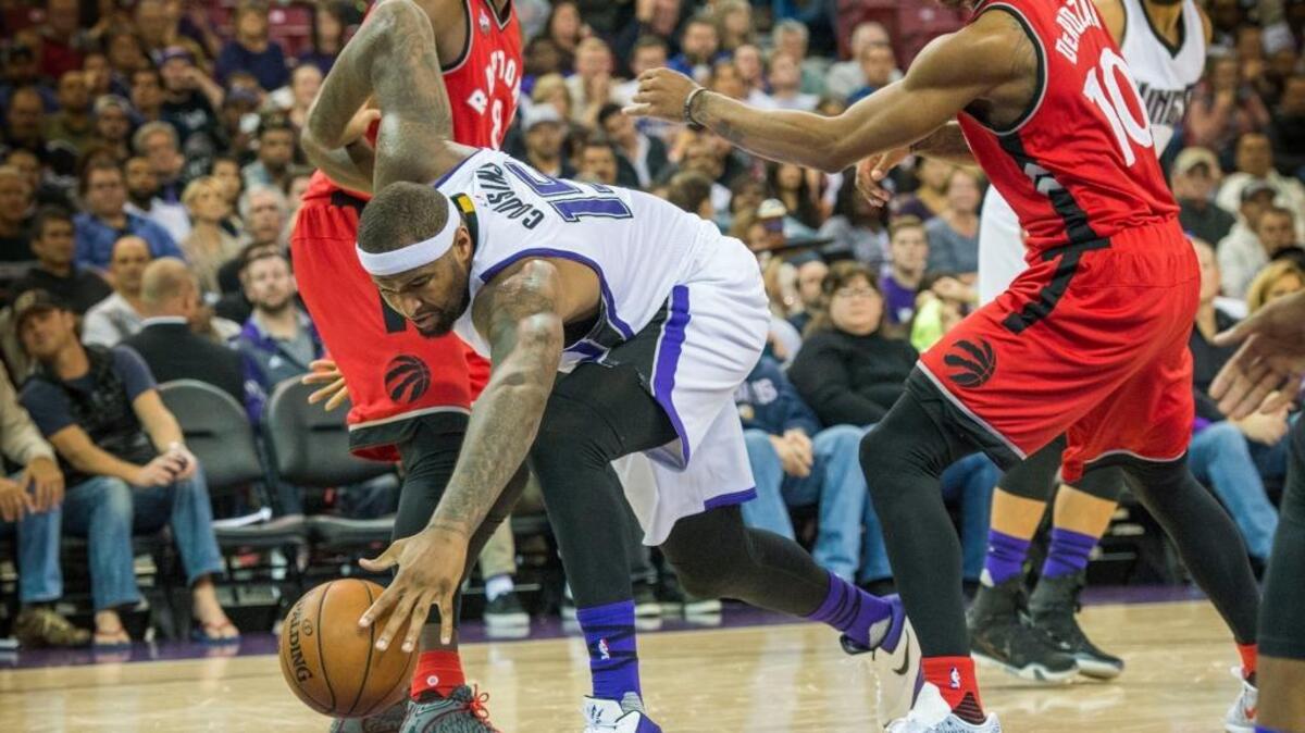Kings forward DeMarcus Cousins pursues a loose ball as Toronto Raptors Bismack Biyombo (8) and DeMar DeRozan (10) converge during an NBA game on Sunday, Nov. 15, 2015 at Sleep Train Arena in Sacramento. Cousins was named the Western Conference Player of the Week.