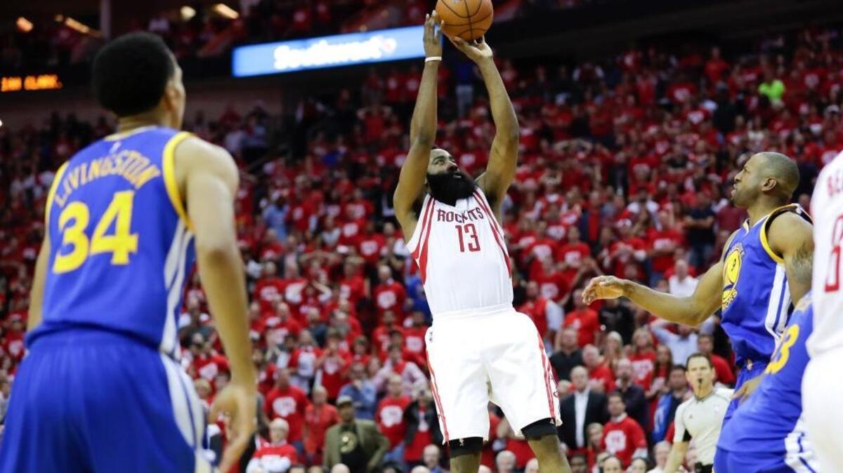 Houston Rockets guard James Harden scores the winning basket during the second half in Game 3 of a first-round NBA basketball playoff series against the Golden State Warriors, Thursday, April 21, 2016, in Houston.
