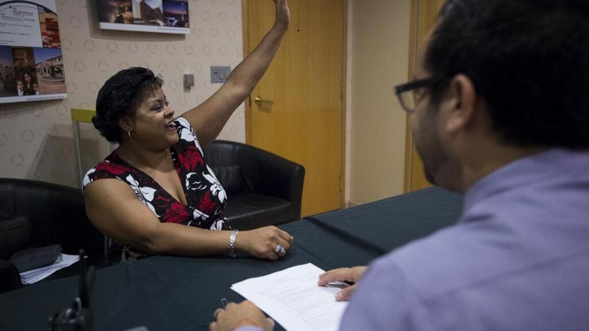 Carolyn Chandler Brown demonstrates how she’ll greet guests during an interview with Ray Daryabigi, director of guest experience, during a job fair at Sleep Train Arena on Thursday, July 14, 2016 in Sacramento, Calif. The Sacramento Kings and other employers hosted a job fair for positions at Golden 1 Center.
