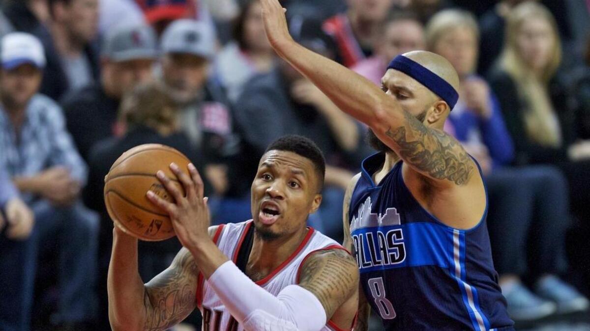 Portland Trail Blazers guard Damian Lillard, left, drives past Dallas Mavericks guard Deron Williams, right, during an NBA basketball game in Portland, Ore., Wednesday, March 23, 2016. Lillard is the Blazers’ leading scorer, averaging 25.7 points per game.