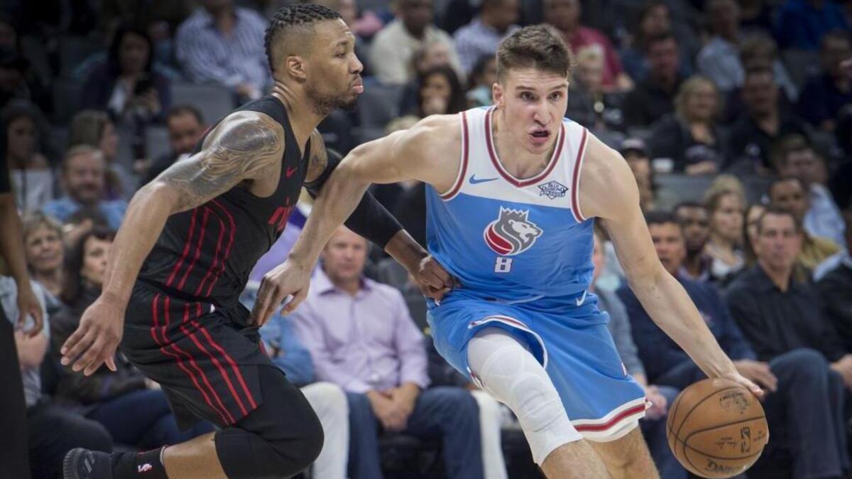 Sacramento Kings guard Bogdan Bogdanovic (8) drives to the basket against the Portland Trail Blazers guard Damian Lillard (0) at Golden 1 Center in on Friday, Feb. 9, 2018.