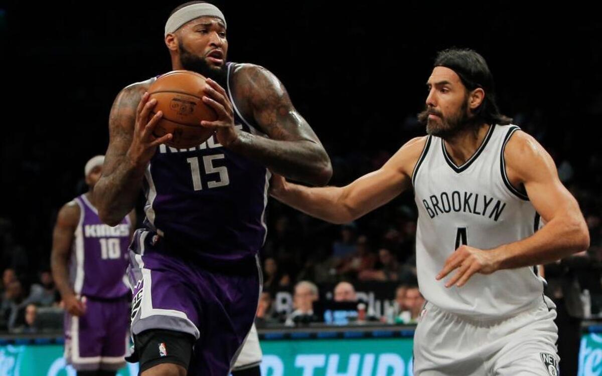 Sacramento Kings center DeMarcus Cousins, left, drives past Brooklyn Nets forward Luis Scola (4) during an NBA basketball game in New York on Sunday, Nov. 27, 2016.