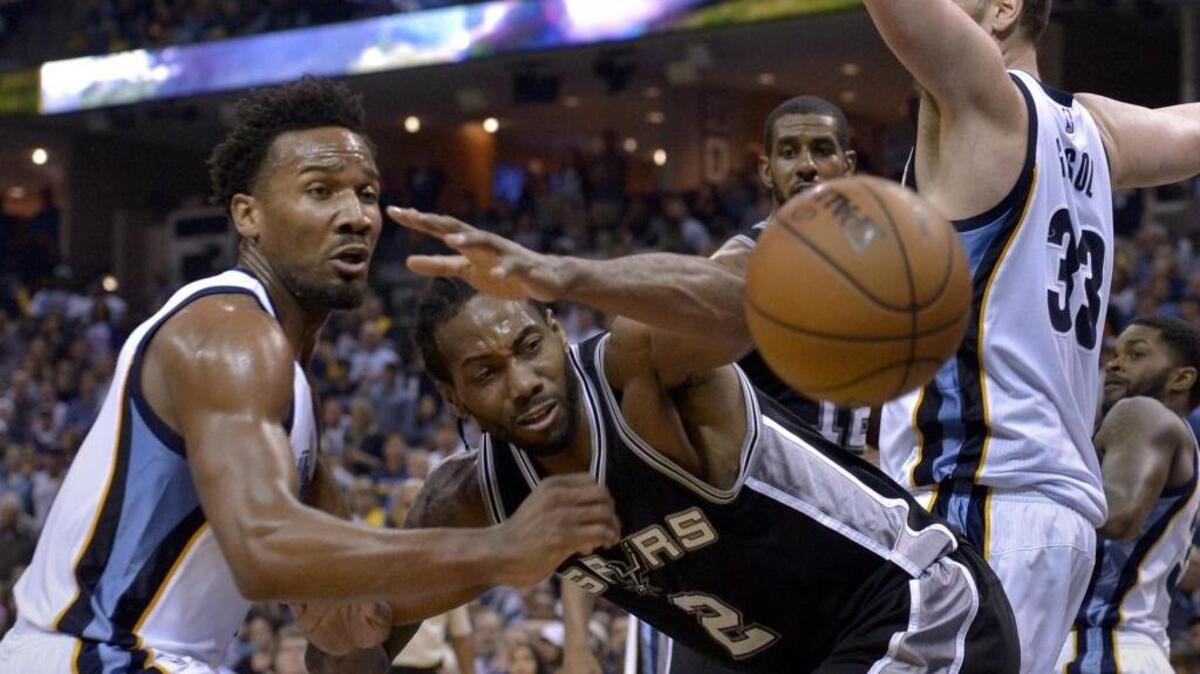San Antonio Spurs forward Kawhi Leonard (2) loses control of the ball while defended by Memphis Grizzlies guard Wayne Selden Jr., left, and center Marc Gasol (33) during the second half of Game 4 in an NBA basketball first-round playoff series Saturday, April 22, 2017, in Memphis, Tenn.