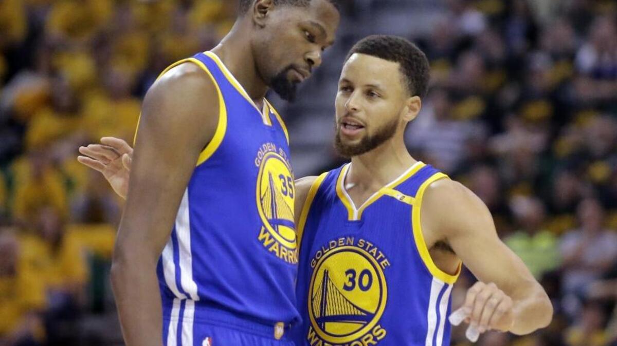 Golden State Warriors Stephen Curry (30) and Kevin Durant (35) talk in the first half during Game 3 of the NBA second-round playoff series against the Utah Jazz, Saturday, May 6, 2017, in Salt Lake City.