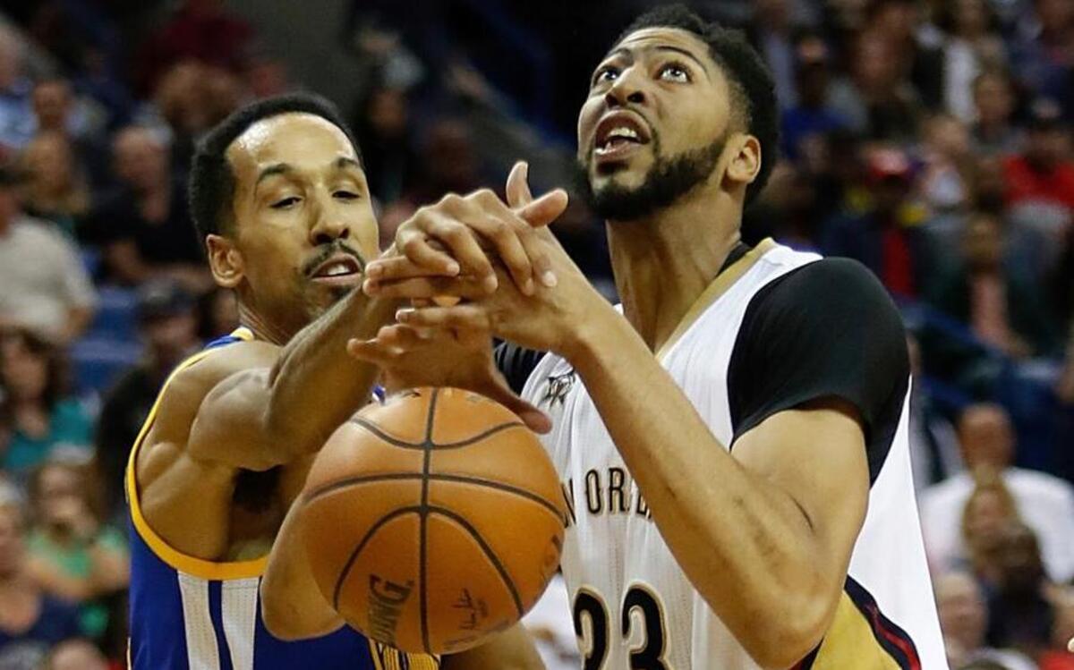 New Orleans Pelicans forward Anthony Davis (23) has the ball stripped by Golden State Warriors guard Shaun Livingston (34) during the first half of Tuesday night’s game in New Orleans.