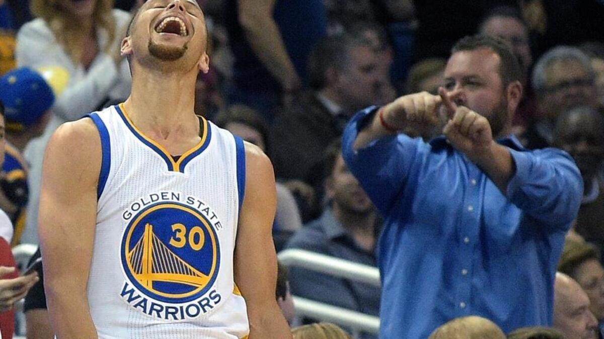 Golden State Warriors guard Stephen Curry (30) celebrates after making a three-pointer from near the half-court line at the end of the third quarter of an NBA basketball game against the Orlando Magic in Orlando, Fla., on Thursday, Feb. 25, 2016. The Warriors won 130-114.