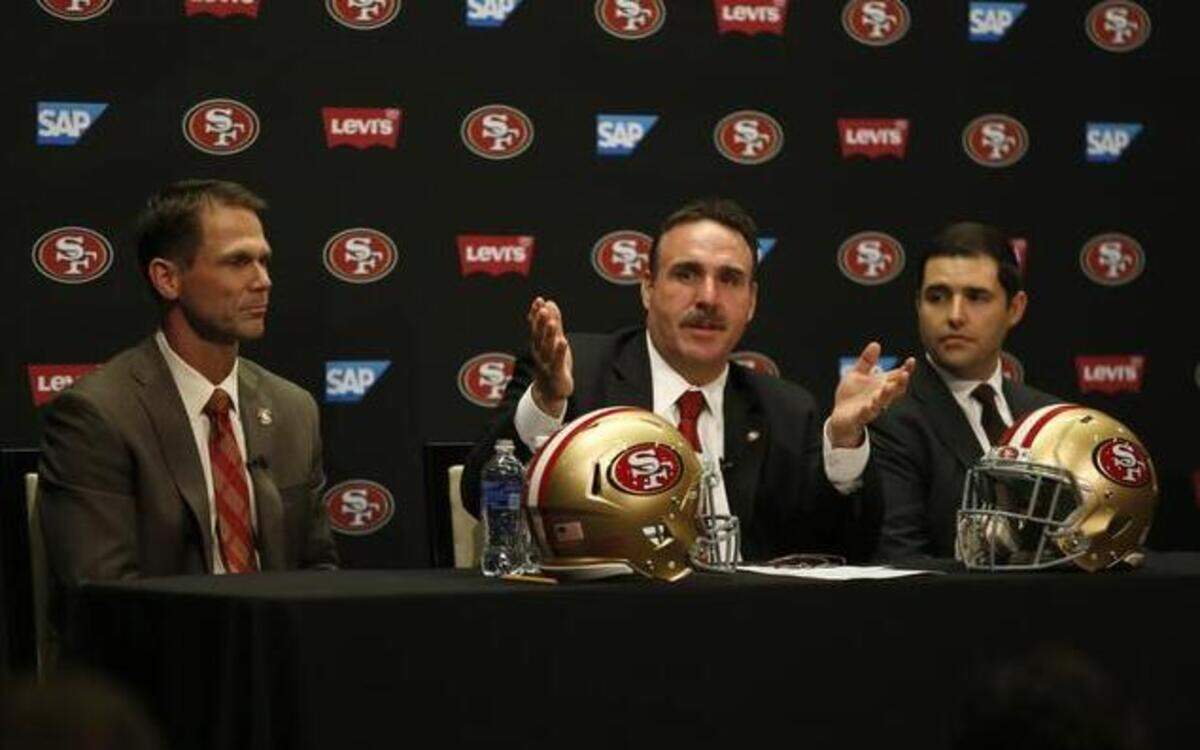 
New San Francisco 49ers head coach Jim Tomsula, center, talks to the media next to general manager Trent Baalke, left, and owner Jed York, right, at Levi's Stadium in Santa Clara, Calif., on Thursday, Jan. 15, 2015.
