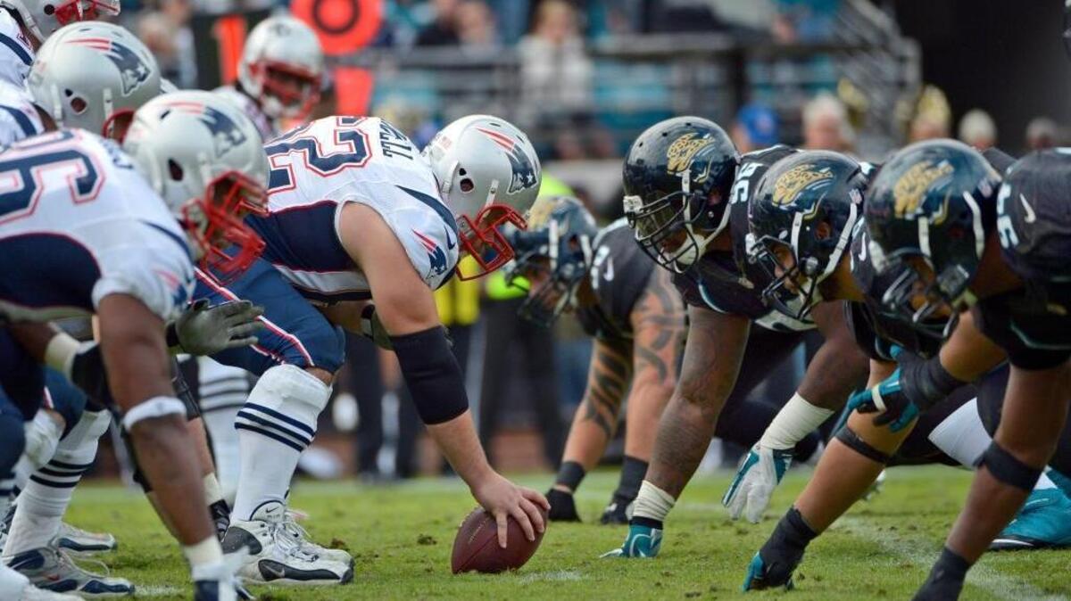 FILE - In this Dec. 23, 2012, file photo, the New England Patriots offense and Jacksonville Jaguars face off in Jacksonville, Fla. The New England Patriots host the Jacksonville Jaguars in the AFC championship on Sunday. U.S. troops deployed overseas will not be able to watch the game via American Forces Network, which is off-air due to the government shutdown.