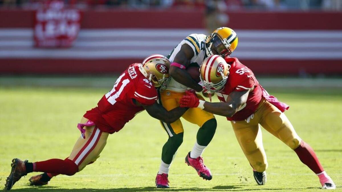 
San Francisco 49ers outside linebacker Ahmad Brooks (55) and strong safety Antoine Bethea (41), tackling Green Bay receiver Ty Montgomery in an earlier NFL game, are back in action Thursday evening as the 49ers face the Seattle Seahawks.
