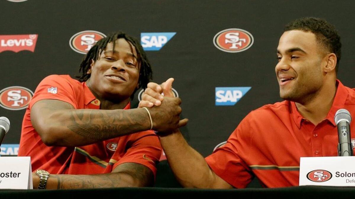 Reuben Foster, left, shakes hands with Solomon Thomas at a 49ers news conference in Santa Clara on April 28, one day after each were selected by the team in the first round of the NFL draft. Thomas was selected No. 3 overall and Foster 31st.