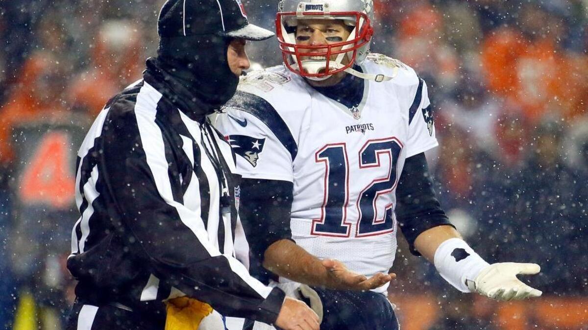 New England Patriots quarterback Tom Brady argues a call with the official during the second half of an NFL football game against the Denver Broncos , Sunday, Nov. 29, 2015, in Denver. The Patriots lost in overtime. It was their first loss of the season. Brady threw for 280 yards and three touchdowns.