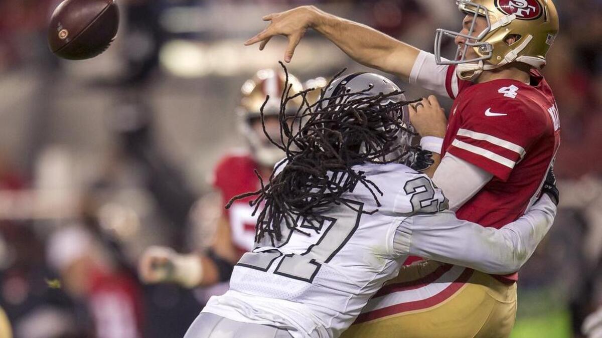 San Francisco 49ers quarterback Nick Mullens (4) is pressured by Oakland Raiders wide receiver Dwayne Harris (17).