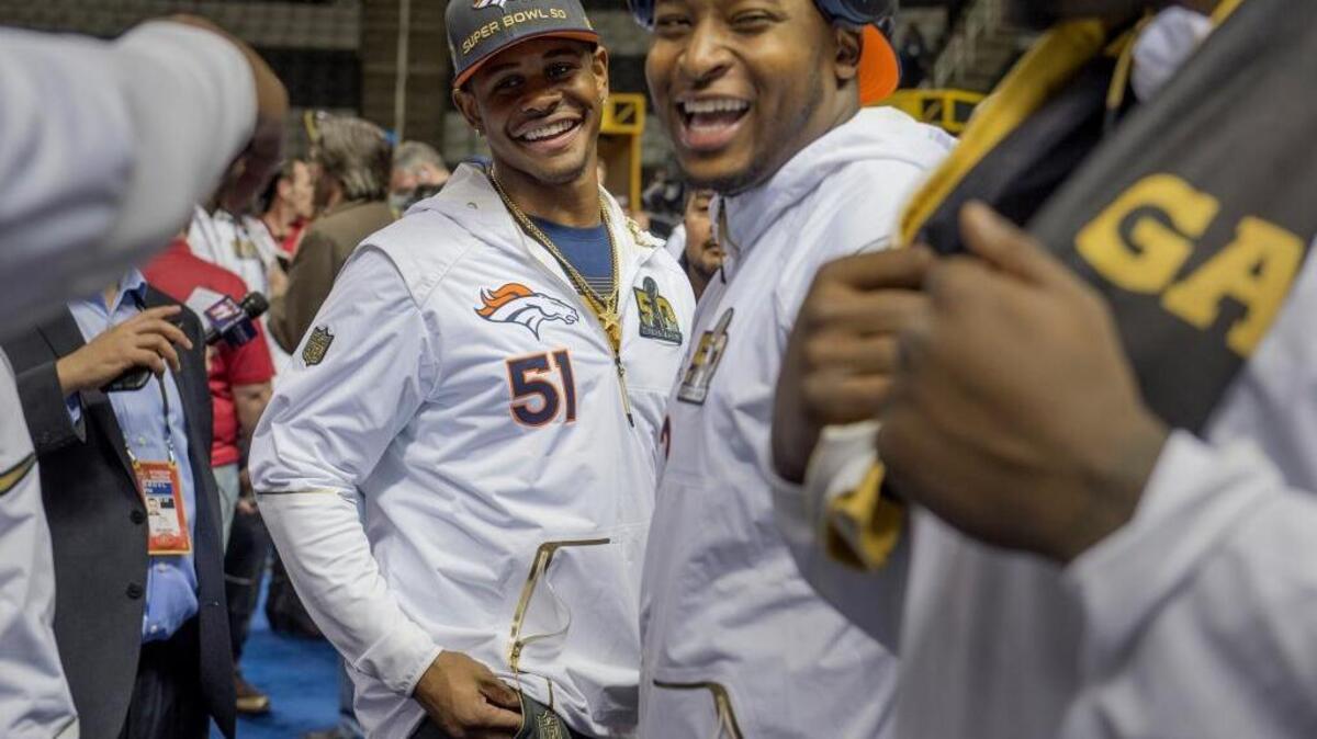Former Sacramento State Hornet and Denver Broncos linebacker Todd Davis (51) jokes with teammates at Super Bowl 50 media day at the SAP Center in San Jose in 2016.