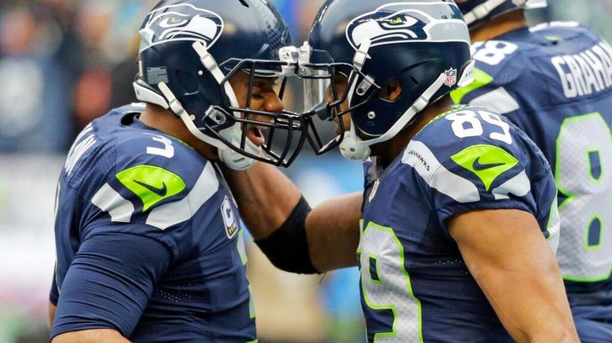 Seattle Seahawks quarterback Russell Wilson, left, celebrates with wide receiver Doug Baldwin, right, after Wilson passed to Baldwin for a touchdown against the Pittsburgh Steelers in the first half of an NFL football game, Sunday, Nov. 29, 2015, in Seattle. Wilson threw five touchdown passes, two to Baldwin.