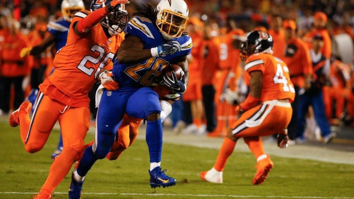 San Diego Chargers running back Melvin Gordon is brought down by Denver Broncos free safety Darian Stewart, left, and cornerback Chris Harris during the second half of an NFL football game Thursday, Oct. 13, 2016, in San Diego. Gordon rushed for 94 yards on 27 carries.