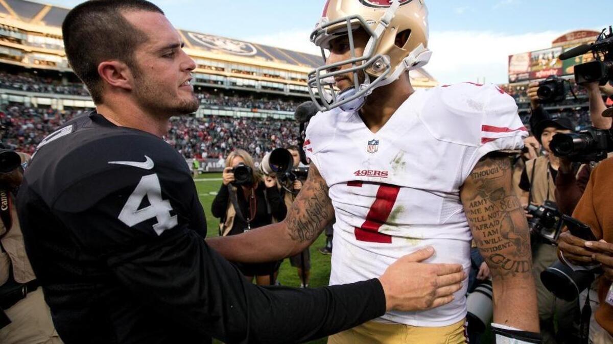 
Derek Carr, left, chats with Colin Kaepernick following the Raiders’ 24-13 win over the 49ers on Sunday December 7, 2014 in Oakland. It was the first meeting between the quarterbacks, who were both selected in the second round with the 36th overall pick of their respective drafts.
