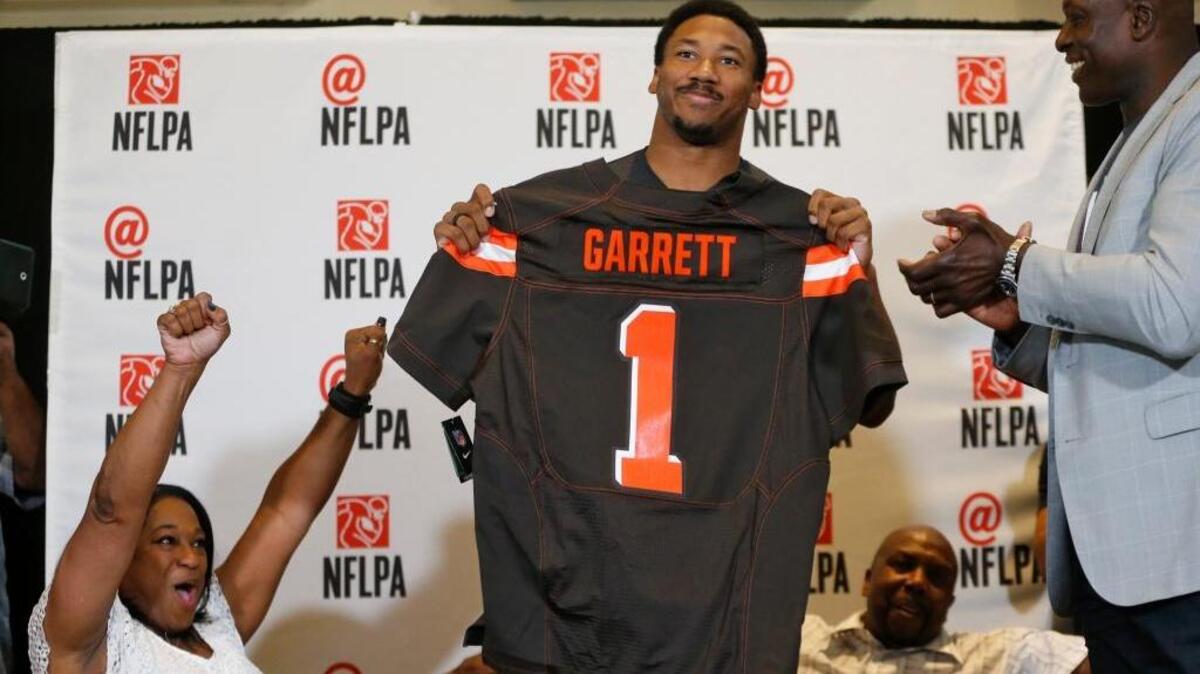 Texas A&M defensive lineman Myles Garrett holds up a Cleveland Browns jersey as he was taken with the first overall pick of the 2017 NFL draft Thursday. Garrett, who was not in attendance at the draft in Philadelphia, celebrated in Arlington, Texas.