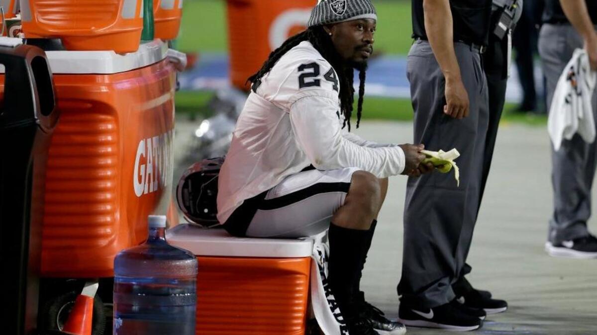 Oakland Raiders running back Marshawn Lynch (24) sits during the national anthem prior to an NFL preseason football game against the Arizona Cardinals, Saturday, Aug. 12, 2017, in Glendale, Ariz.