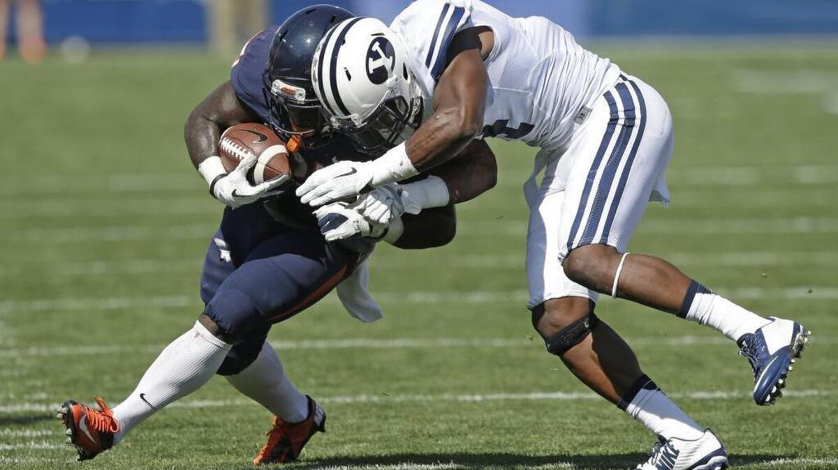 
BYU’s Rob Daniel brings down Virginia running back Kevin Parks in a game Saturday, Sept. 20, 2014, in Provo, Utah. 
