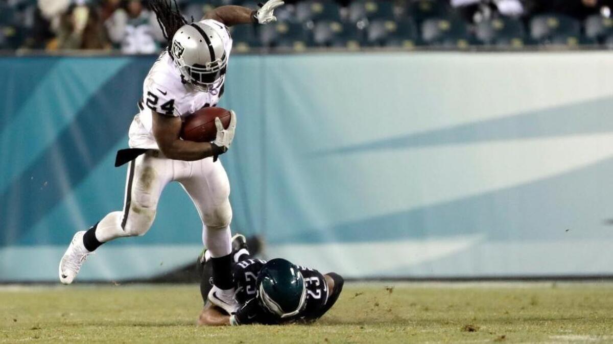Oakland Raiders' Marshawn Lynch rushes past Philadelphia Eagles' Rodney McLeod on Monday in Philadelphia.