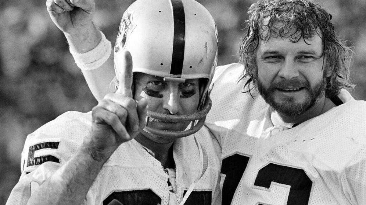 Raiders wide receiver Fred Biletnikoff, left, and quarterback Ken Stabler proudly hold up one finger, indicating their team is No. 1, after Oakland defeated the Minnesota Vikings in the Super Bowl in Pasadena on Jan. 9, 1977. Stabler will be posthumously inducted into the Pro Football Hall of Fame on Saturday. “I told my wife, we’ll just dig him up and prop him in a chair at the Hall of Fame so he can enjoy it,” Biletnikoff said.