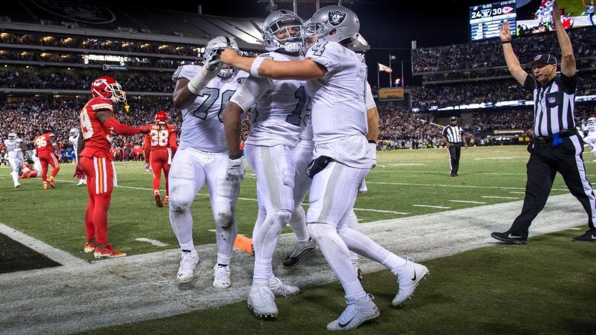 Raiders wide receiver Michael Crabtree, center, is congratulated by teammates after scoring the game-winning touchdown against the Kansas City Chiefs on Oct. 19 in Oakland.