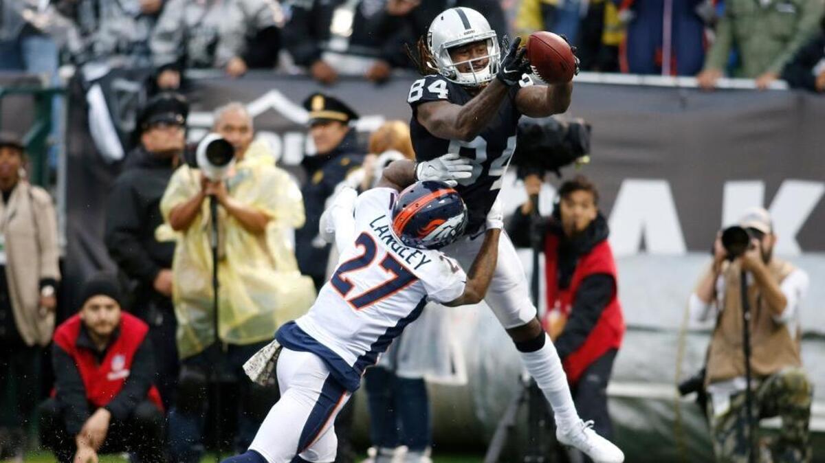 Broncos cornerback Brendan Langley (27) is called for pass interference on Oakland Raiders wide receiver Cordarrelle Patterson on Nov. 26.