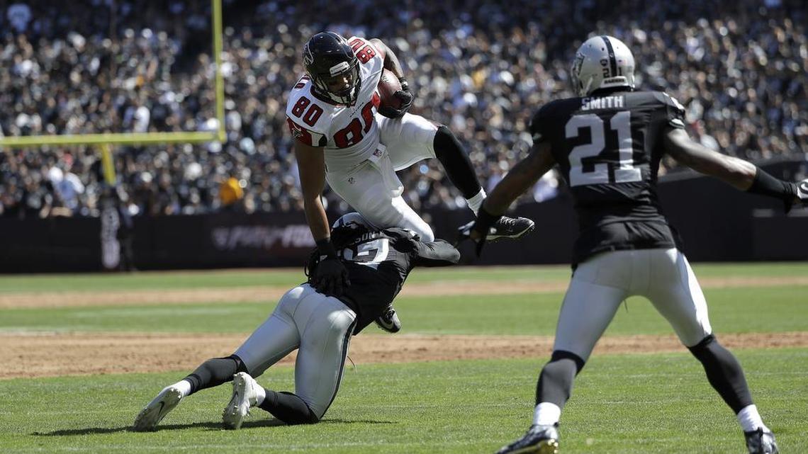Atlanta Falcons tight end Levine Toilolo (80) is tackled by Raiders free safety Reggie Nelson in Oakland on Sunday, Sept. 18, 2016.