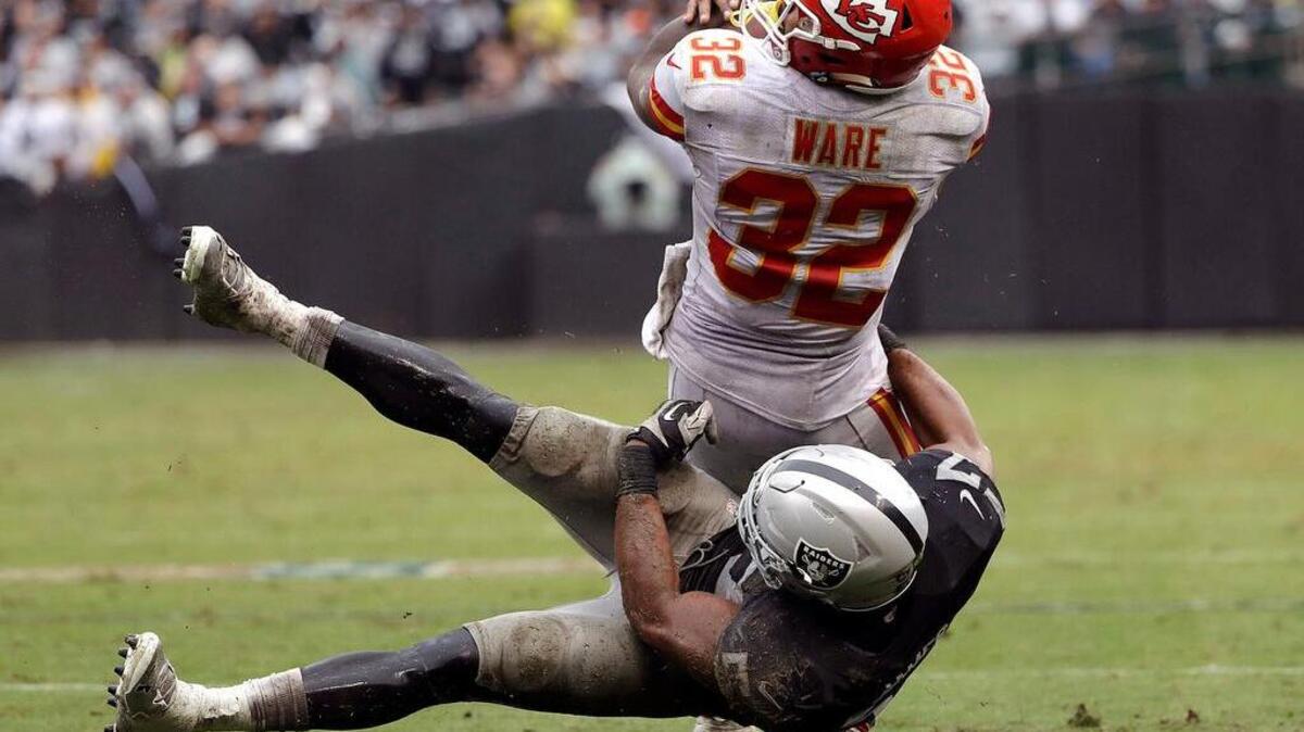 Chiefs running back Spencer Ware (32) is tackled by Raiders linebacker Khalil Mack (52) during the second half of their game Oct. 16 in Oakland. Last year against the Broncos, this week’s opponent, Mack had five sacks.