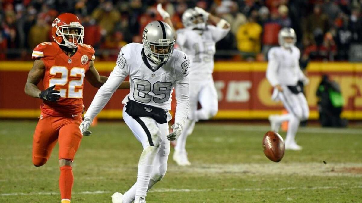 Raiders wide receiver Amari Cooper (89) can’t reach a pass from quarterback Derek Carr with Kansas City Chiefs defensive back Marcus Peters running behind him during the second half of Thursday night’s game at Arrowhead Stadium in Kansas City, Mo. It was one of 24 passes thrown by Carr that found the ground rather than a receiver in the Raiders’ 21-13 loss.