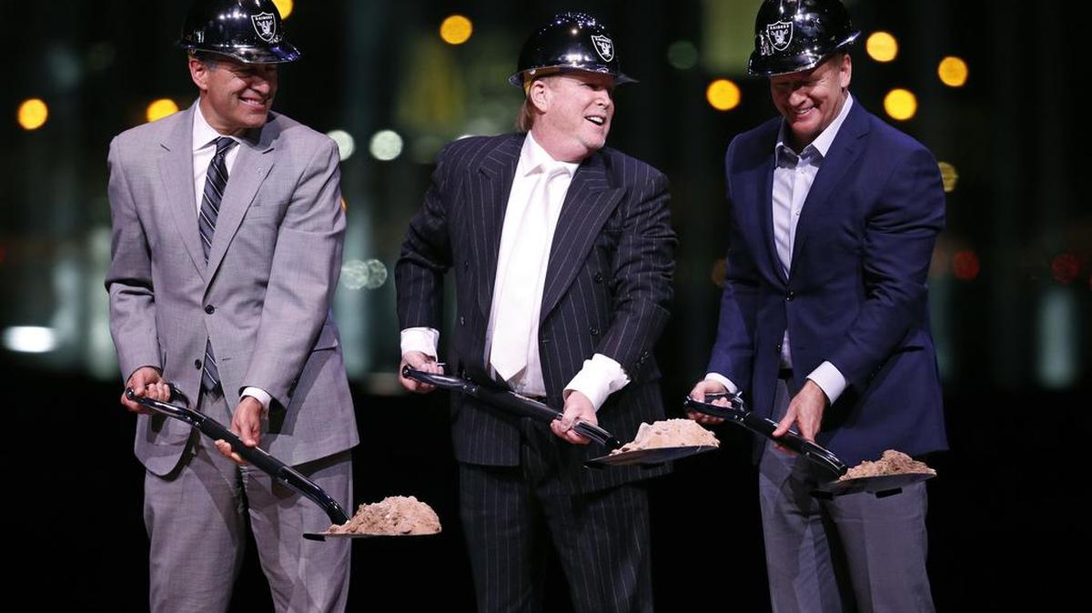 Raiders owner Mark Davis, center, poses for photographers beside Nevada Gov. Brian Sandoval, left, and NFL commissioner Roger Goodell during a ceremonial groundbreaking for the Oakland Raiders' stadium Monday, Nov. 13, 2017, in Las Vegas.