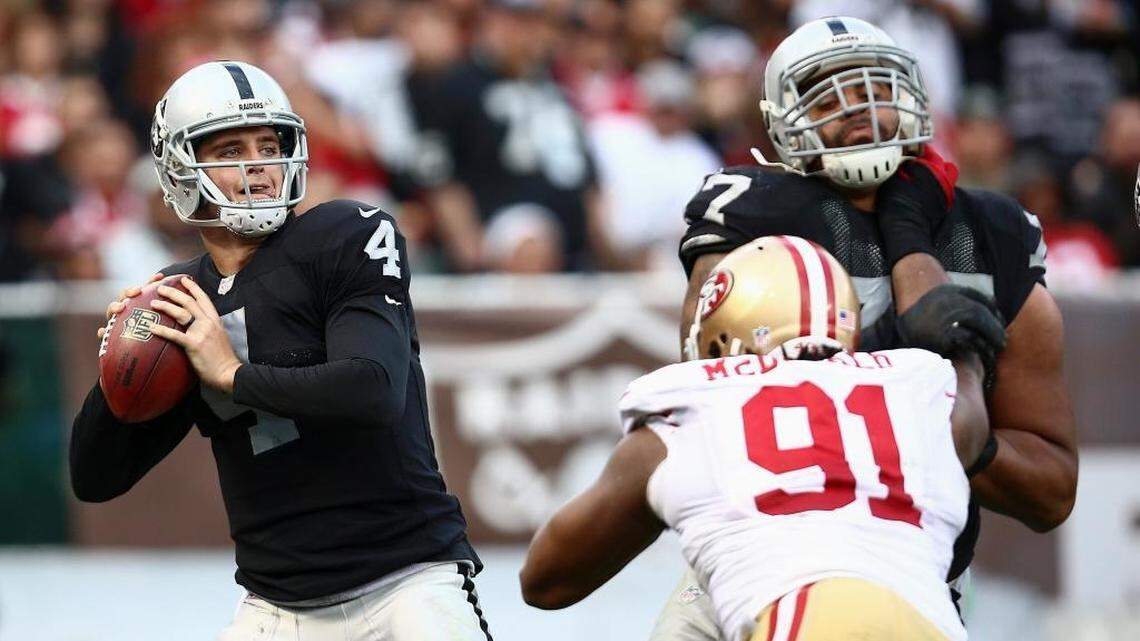 Raiders quarterback Derek Carr looks to pass against the 49ers in the teams' last meeting Dec. 7, 2014, in Oakland. The Raiders will play the 49ers at Levi's Stadium sometime in the 2018-19 season.