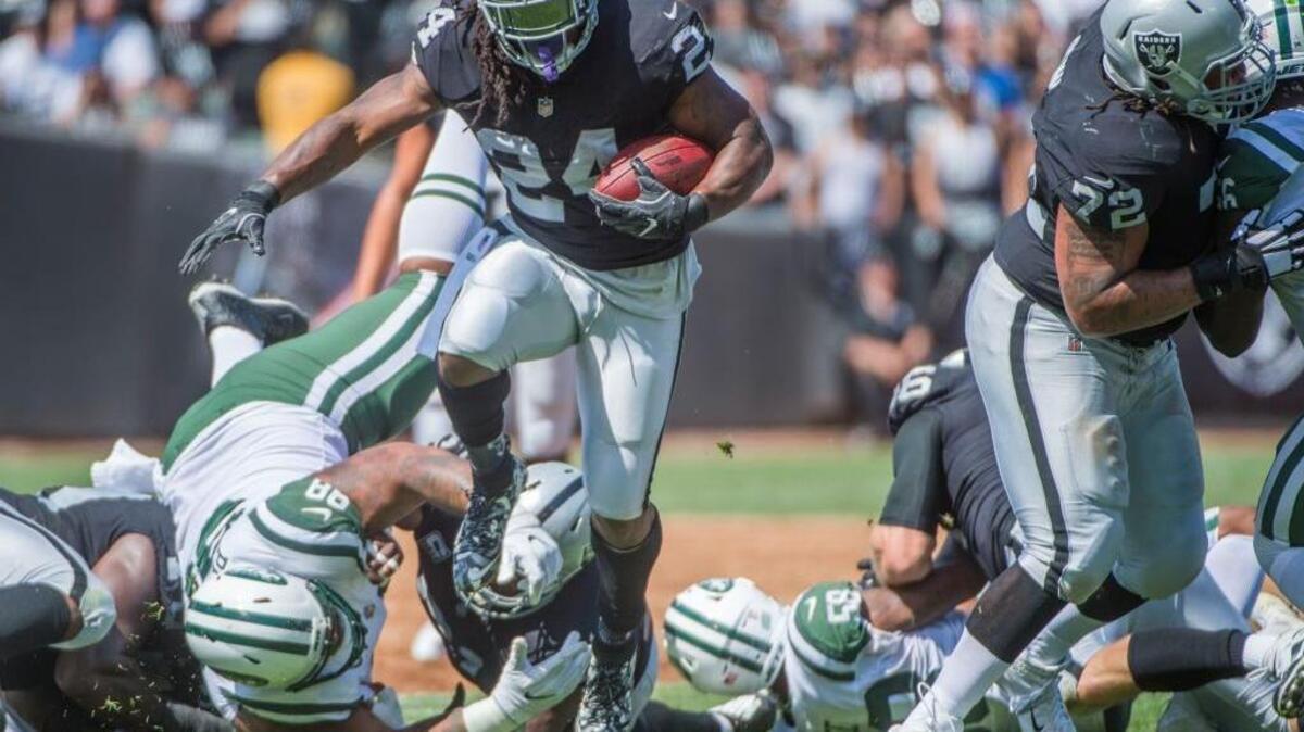 Oakland Raiders running back Marshawn Lynch (24) runs for a first down during the game against the New York Jets on Sept. 17, 2017 at the Coliseum.