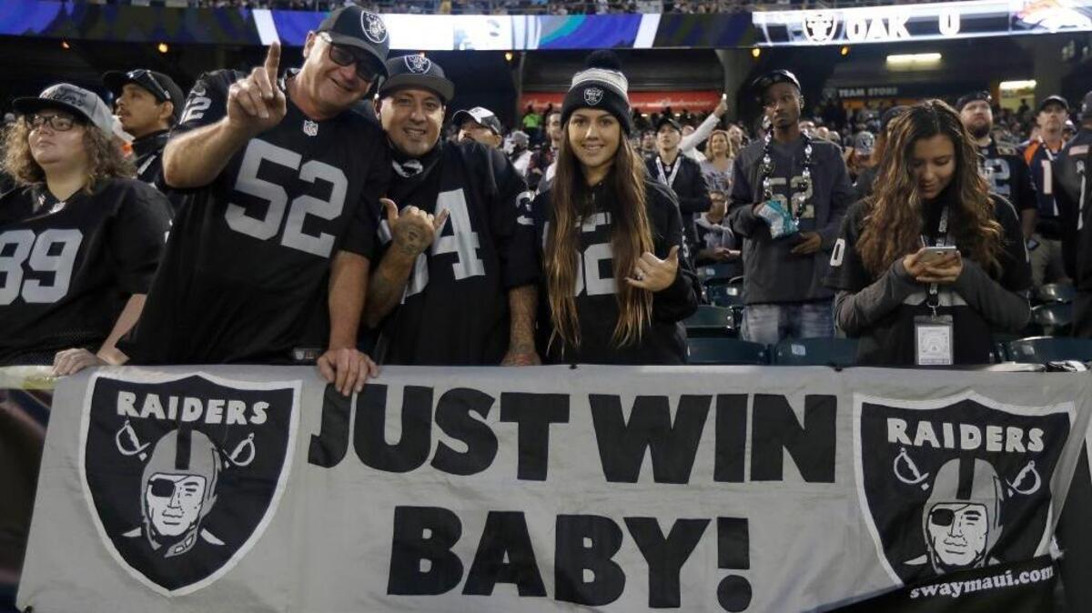 Oakland Raiders fans celebrate during the team’s NFL football game against the Denver Broncos in Oakland, Calif., on Sunday, Nov. 6, 2016.
